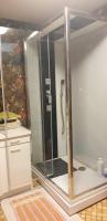 a shower with a glass door in a bathroom at Horizon Aubrac Laguiole in Laguiole