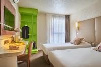 a hotel room with two beds and a table and a desk at Campanile Lyon Centre - Berges du Rhône in Lyon