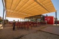 a group of tables and chairs under a yellow roof at Iate Glória Sem-fim Monsaraz in Monsaraz