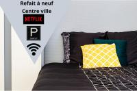 Łóżko lub łóżka w pokoju w obiekcie LD-Location Hôtel