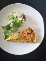 a white plate with a piece of pizza and a salad at Logis hôtel Annecy nord &#47; Argonay in Argonay