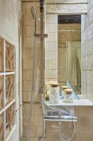 a shower in a bathroom with a mirror at Apartment in heart of Marais by Studio prestige in Paris