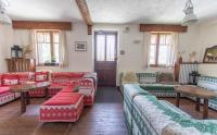 a living room with red and green couches and tables at Hotel Le Chamois in L&#39;Alpe-d&#39;Huez