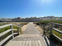 a wooden boardwalk leading down to the beach at Apartment L&#39;Oustalet-3 by Interhome in Mimizan-Plage
