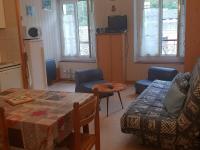 a living room with a couch and a table at Appartement Cauterets, 2 pièces, 4 personnes - FR-1-234-299 in Cauterets