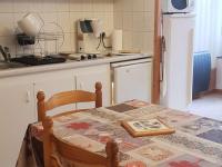 a kitchen with a table and a kitchen with a refrigerator at Appartement Cauterets, 2 pièces, 4 personnes - FR-1-234-299 in Cauterets