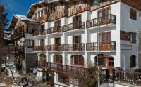 an apartment building with balconies on the side of it at Hotel Le Chamois in L&#39;Alpe-d&#39;Huez