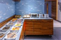 a buffet line with plates of food on it at 雲沐行旅 Hotel Cloud Arena-Daan in Taipei