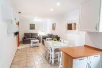 a kitchen and living room with a table and a couch at Apartamentos Gravina in Tarifa
