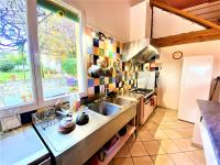 a kitchen with a sink and a large window at CHAMBRES D&#39;HOTES 2 à 4p ou GITE DE GROUPE 15p, 7 ch, 6 sdb, parc et salle de réception in Villeneuve-de-Berg