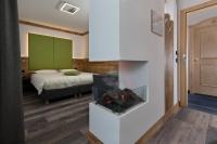 A bed or beds in a room at Hotel Chalet Sas Morin