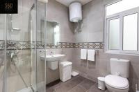 a bathroom with a toilet and a sink and a shower at Spacious, beautiful central penthouse with BBQ by 360 Estates in Tal-Pietà