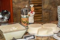 a figurine of a chef standing next to a cake at VOA Hotel Caxambu in Caxambu