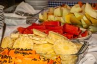 a plate of fruits and vegetables on a table at VOA Hotel Caxambu in Caxambu