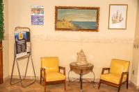 a room with two chairs and a table and a painting at VOA Hotel Caxambu in Caxambu
