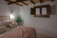 Postel nebo postele na pokoji v ubytování Suites Jardines de la Alhambra