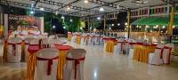a group of tables and chairs in a banquet hall at Mango Valley Resort Ganpatipule in Ratnagiri