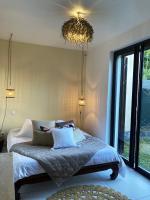 a bedroom with a bed with pillows and a chandelier at Maison de 3 chambres avec jardin clos et wifi a Saint Denis in Saint-Denis