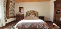 a bedroom with a large bed in a room at La chambre d&#39;hôte du Petit Mazilloux in Présailles