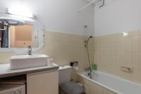 a bathroom with a sink and a toilet and a tub at Les Narcisses - aux pieds des pistes in Saint-Léger-les-Mélèzes