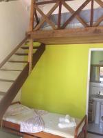 a bedroom with two bunk beds with a yellow wall at Hospedagem Recanto dos Ties in Abraão