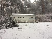 a house with a snow covered yard in front of it at Tranquil bungalow in Lille with garden in Lille