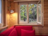 a red couch in a room with a window at Tranquil bungalow in Lille with garden in Lille