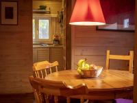 a kitchen with a wooden table with a bowl of fruit at Tranquil bungalow in Lille with garden in Lille