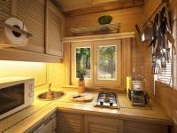 a kitchen with a stove and a sink and a window at Tranquil bungalow in Lille with garden in Lille