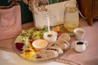 a plate of food with bread and salad and a drink at Queen Love Homestay in Hualien City
