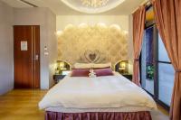 a bedroom with a large bed and a large window at Queen Love Homestay in Hualien City