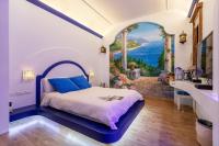 a bedroom with a bed and a bathroom with a window at Queen Love Homestay in Hualien City