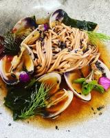 a plate of food with pasta and vegetables on a table at Hôtel Le Cobh in Ploërmel