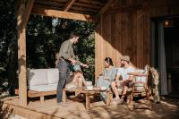 a man standing on a deck with a group of people at Domaine St-Amand in Saint-Amand-de-Coly