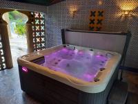 a jacuzzi tub with purple lighting in a room at Résidence Royal Palmeraie in Aubagne