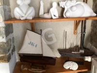 a shelf with white figurines and a boat on it at Maison Le Bernard, 5 pièces, 6 personnes - FR-1-357-253 in Le Bernard