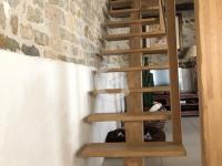 a wooden staircase in a room with a brick wall at Maison Le Bernard, 5 pièces, 6 personnes - FR-1-357-253 in Le Bernard