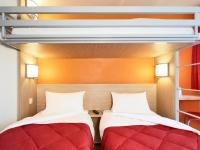 two beds in a room with a bunk bed at Premiere Classe Orleans Ouest - La Chapelle St Mesmin in La Chapelle-Saint-Mesmin