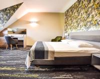 una habitación de hotel con una cama y un escritorio en Leśny Dwór, en Radom
