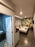 Postel nebo postele na pokoji v ubytování Aen Guy Boutique Hotel