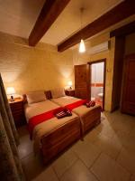 a bedroom with a large bed in a room at Ta’ Peppi Farmhouse in Qala