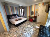 Postel nebo postele na pokoji v ubytování Aen Guy Boutique Hotel