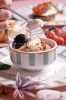 a bowl of cereal with ice cream and berries on a table at Imperial Hotel Cork City in Cork