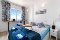 A bed or beds in a room at 50 shades of blue