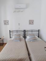 A bed or beds in a room at Villa Stella Family House