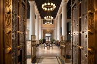 a hallway with tables and chairs and a chandelier at The Liberty Trust in Roanoke