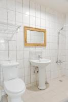 a white bathroom with a toilet and a sink at Star-Moon B&amp;B Green Island in Green Island