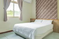 a bedroom with a large bed and a window at Star-Moon B&amp;B Green Island in Green Island