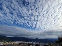 a cloudy sky with picnic tables in a parking lot at Naluwan Villa in Ren&#39;ai