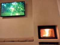A television and/or entertainment centre at Casa Cueva El Naranjo Rocabella